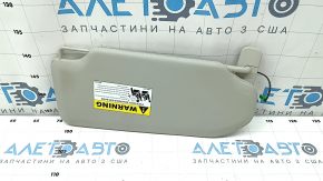 Козырёк солнцезащитный левый для Volvo XC90 2016-2022, вид сбоку с информационной наклейкой.