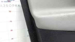 Крупный план потертости на обшивке двери передней левой Chevrolet Equinox.