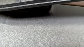 Крупный план поверхности кожаного подлокотника двери Volkswagen ID.4 с небольшой потертостью.