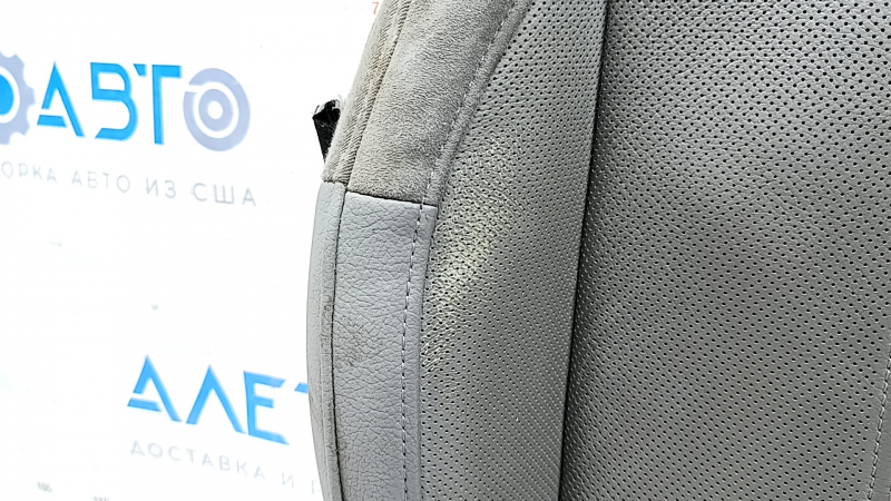 Крупный план обшивки водительского сидения Audi A4 B9 с перфорацией, видно состояние материала.