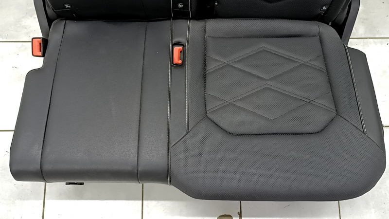 Крупный план на сиденье VW Atlas, видны следы эксплуатации, без серьёзных повреждений.