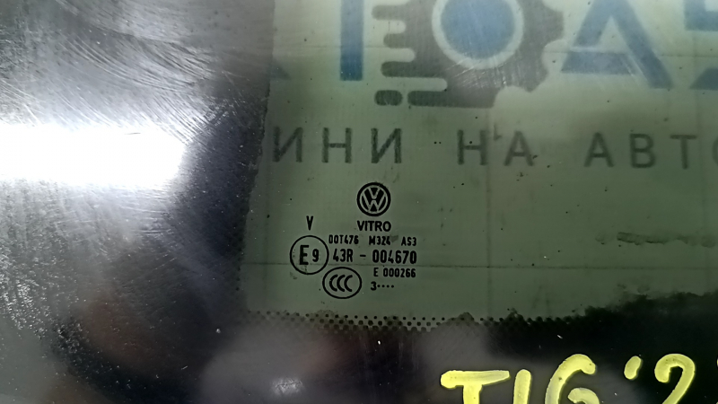 Близкий план маркировок на форточке задней левой Volkswagen Tiguan 2018-2024, все детали на месте.