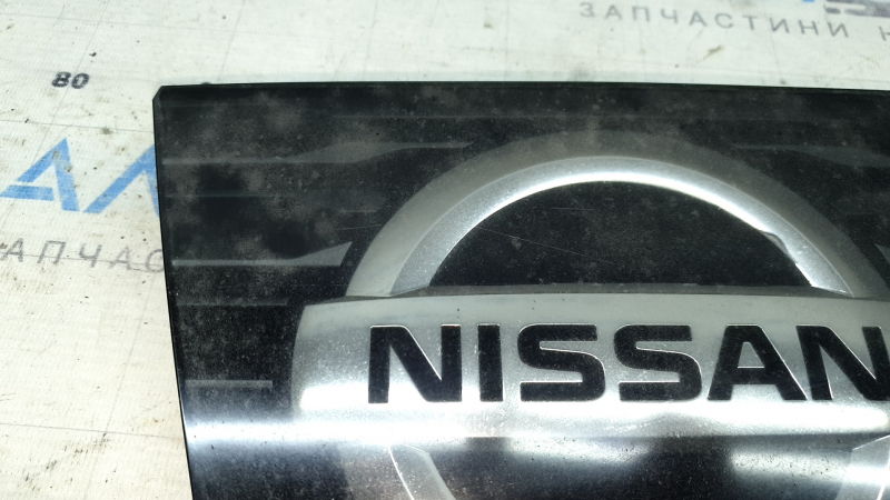 Крупный план эмблемы передней решётки Nissan Rogue, подчеркивающий её состояние.
